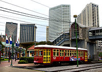 NewOrleansHUDRed StreetcarRiverfrontCanal.jpg