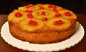 Pineapple upside-down cake, which is topped with pineapple and maraschino cherries.