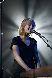 Musician Emily Haines playing keyboard.