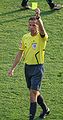 A referee issuing a yellow card.