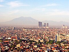 Kota Surabaya dengan latar belakang pegunungan Arjuno-Welirang di kejauhan.