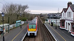 175009 passing Llanfairpwll railway station.