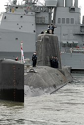 Astute manoeuvring into position at Naval Station Norfolk in Norfolk Virginia, November 2011 US Navy 111128-N-NK458-054 ailors aboard the Royal Navy submarine HMS Astute (S119) stand in formation topside as the ship is maneuvered into posit.jpg