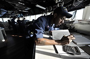 US Navy 120118-N-IR479-026 Quartermaster 2nd Class Cedrick Collins makes a log entry aboard the guided-missile destroyer USS Russell (DDG 59).jpg