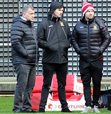 Shaun Wane, Bateman and Darrell Goulding at a Wigan match in 2018 Wane, Bateman & Goulding.jpg