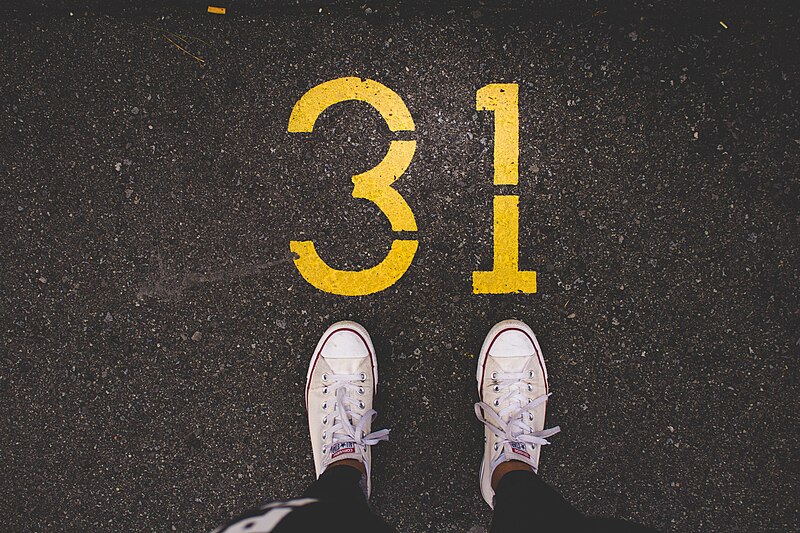 File:White sneakers on asphalt (Unsplash).jpg