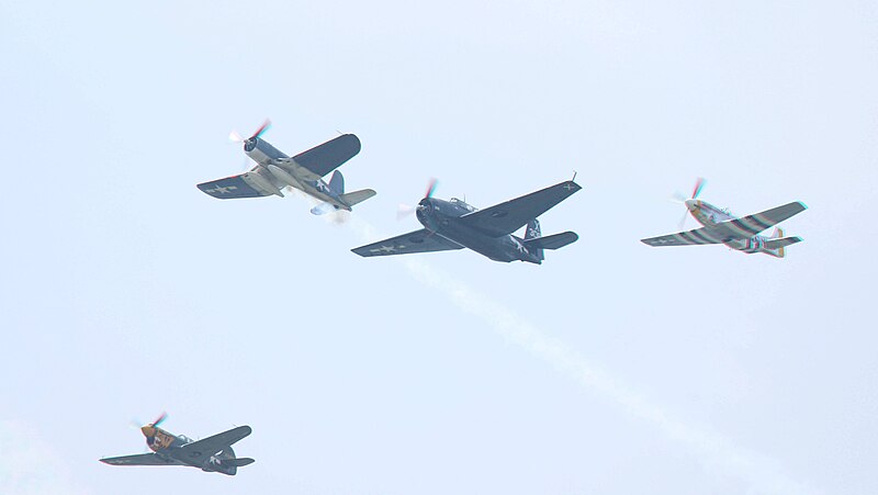 File:'Missing Man' F4U exiting formation of TBM, P-40, and P-51 (all Texas Flying Legends Museum), a little further out (17311409690).jpg