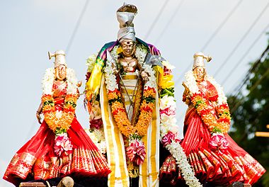 Murugan with Devasena (on right of image) and Valli (on left of image).