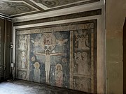 Upper part of the reredos of the former chapel, later partitioned horizontally by a mezzanine. A mainframe computer was installed across the painted mural, which is in the distinctive Beuronese style