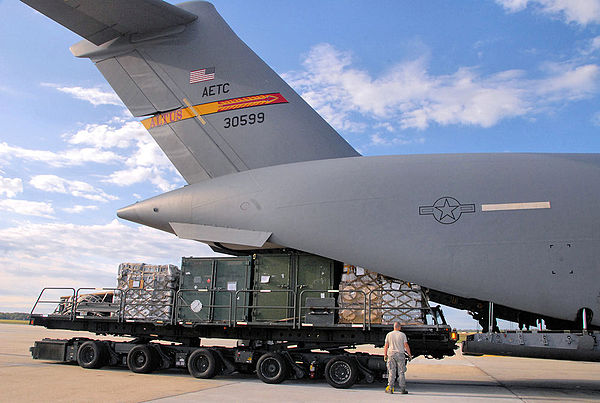 An airman from the 305th Aerial Port Squadron, McGuire Air Force Base, N.J., helps load a C-17 Globemaster III flown by a crew assigned to the 58th Ai