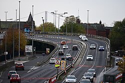 The Daltry Street Flyover along the A63 from the Porter Street Bridge in Kingston upon Hull. Note the peeling 'Reduce Speed Now' signage.