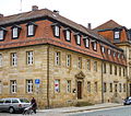 Closed row of three sandstone cuboid houses