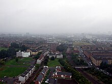 View looking west from Whitevale Tower, including the Bellgrove Hotel (left), spare ground, refurbished maisonettes and new houses (centre), Bellgrove railway station and tracks and older tenements in Dennistoun (right) Bellgrove from Whitevale Tower.JPG