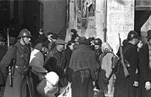 Vichy police escorting French Jewish citizens for deportation during the Marseille roundup, January 1943. Bundesarchiv Bild 101I-027-1477-30, Marseille, Hafenviertel. Deportation von Juden.jpg