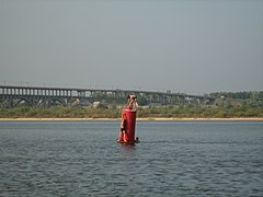 Children playing on a buoy in the Volga