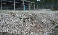 Biosolids composting plant biofilter mound - note sprinkler visible front right to maintain proper moisture level for optimum functioning CVRD5biofilter.air.exhaust.jpg