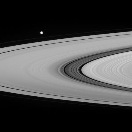 The Cassini Division imaged from the Cassini spacecraft. The Huygens Gap lies at its right border; the Laplace Gap is towards the center. A number of other, narrower gaps are also present. The moon in the background is Mimas.