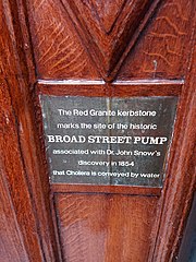 A plaque marking the significance of the red granite and the pump. Located on the wall of the John Snow pub, straight across from the pump itself.