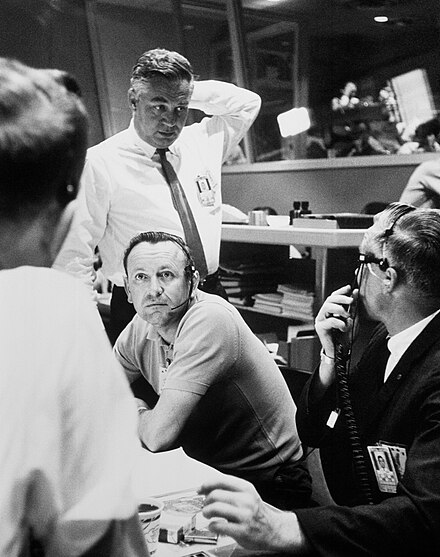 Chris Kraft (seated) confers with Walt Williams and others during Mercury-Atlas 9.