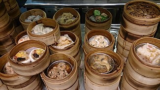 Stacks of bamboo baskets, each containing two to three small portions