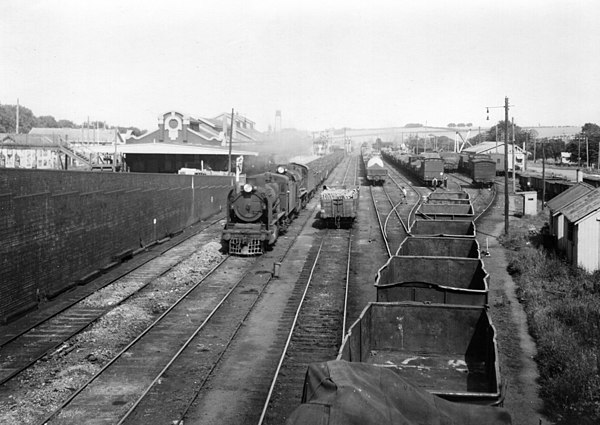 Double headed coal train passing westbound through Warragul station ~1920