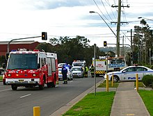 Police, fire, and medical services at the scene of a traffic collision in New South Wales, Australia Emergency sevices attending the accident - Flickr - Highway Patrol Images.jpg