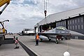 Romanian air force ground crews lifting an F-16 for maintenance.