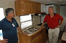 Congressman Mark Foley checks out the travel trailers that FEMA provided as temporary housing in Port Charlotte FEMA - 10935 - Photograph by Mark Wolfe taken on 09-16-2004 in Florida.jpg