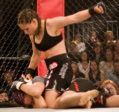 Image 2Gina Carano applying a Ground-and-Pound on her opponent. (from Mixed martial arts)