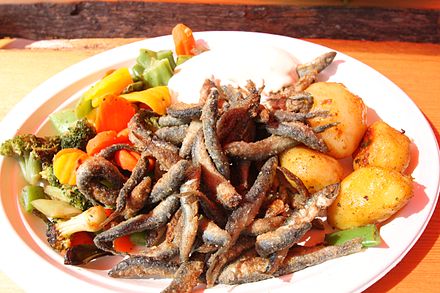 Fried vendace with potatoes and vegetables at an outdoor market in Finland