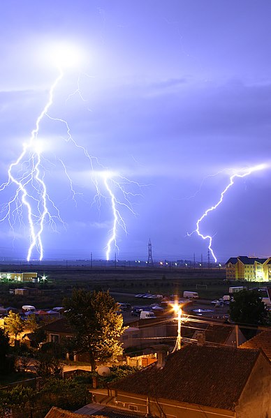 Lightning is an example of plasma present at Earth's surface. Typically, lightning discharges 30,000 amperes at up to 100 million volts, and emits lig