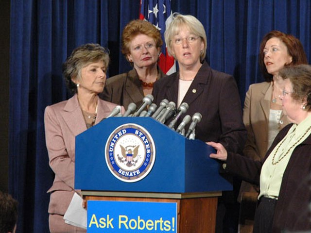 Senator Murray at the podium, joined by (left to right), Sen. Barbara Boxer (D-CA), Sen. Debbie Stabenow (D-MI), Sen. Maria Cantwell (D-WA) and Sen. B