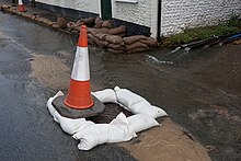 Sanitary manhole inflow due to a flood Manhole and sandbagging outside Cricketers Cottage - geograph.org.uk - 3874272.jpg