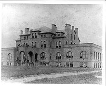 North Carolina State College of Agriculture and Mechanic Arts with president Alexander Q. Holladay, faculty, and first freshman class posing in front of the college's main building (later named Holladay Hall). Date: 1890 NCSU Holiday Hall.JPG