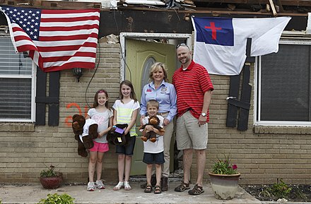 Governor Mary Fallin stands with a family that survived the devastating 2013 Moore tornado with winds exceeding 200 miles per hour