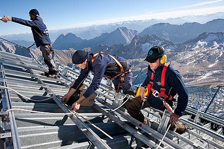 Workers constructing a photovoltaic system