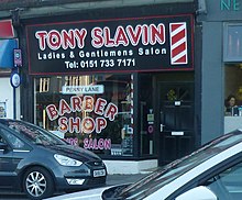 The barber shop (pictured in 2018) formerly owned by Harry Bioletti, who is referred to in the song as a barber showing photographs / Of every head he's had the pleasure to know.