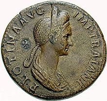 Moneda que representa a una mujer de perfil en busto, con un elaborado peinado alto, rodeada de inscripciones.