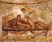 Wall painting from the Lupanar (brothel) of Pompeii, with the woman presumed to be a prostitute wearing a bra Pompeii - Lupanar - Erotic Scene - MAN.jpg