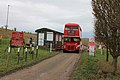 RM1005 leaves the training area through the access gate, heading east away from Imber onto the public road to Gore Cross. Despite wearing blinds for route 23A to Tilshead, the bus is infact empty - it visited Imber during one of the other open days (3 January 2011), to attend the cheque presentation to St. Giles Church for the previous year's bus service.