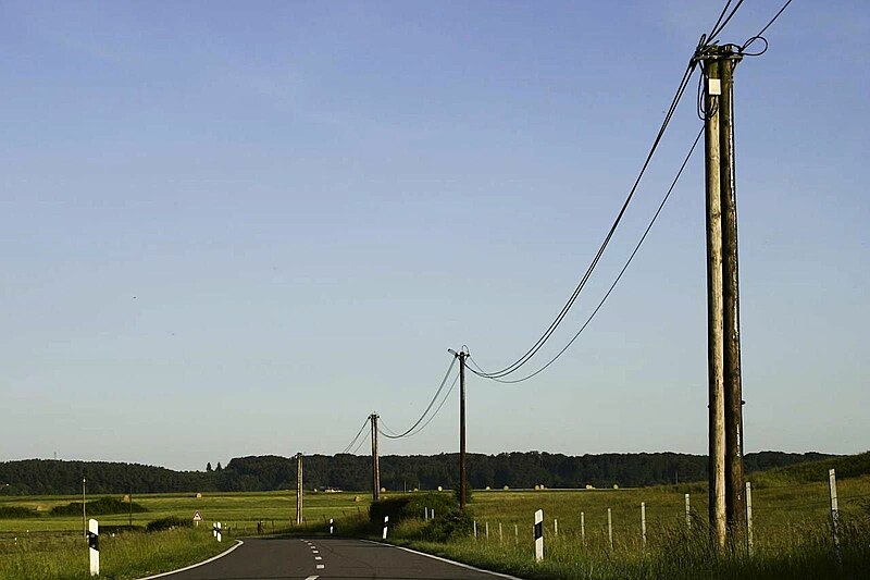 File:Telephone line by road.jpg