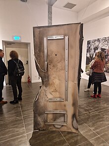 A broken metal door that was included in the photograph exhibition The photography exhibition Be'eri by the photographer Micha Brikman (7).jpg