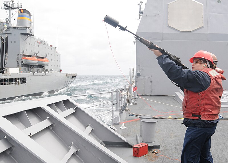 File:US Navy 100615-N-3327M-060 Fire Controlman 2nd Class Lacey Robertson, from Conroe, Texas, fires a shot line during a replenishment at sea with the Military Sealift Command fleet replenishment oiler USNS Guadaloupe (T-AO 200).jpg