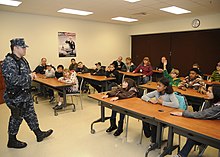 Military brats on a school field trip to the base security department, Naval Air Station Whidbey Island, Washington state, US US Navy 110330-N-ZK021-006 Master-at-Arms 2nd Class Cody Abernathy, assigned to Naval Air Station Whidbey Island base security, answers questions f.jpg