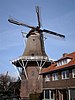 A Dutch smock mill on a tall brick base