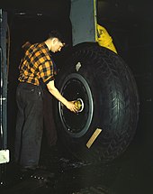 Inspection of the landing gear of a transport plane at Willow Run