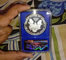 2015 American Silver Eagle (Reverse side; Proof "30th ANNIVERSARY" on edge and made of .999 fine silver), in an NGC slab. 2015 American Silver Eagle .999 Fine Silver Dollar by NGC.jpg