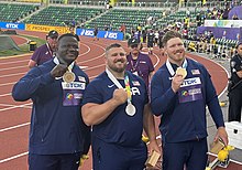 Josh Awotunde (left), Joe Kovacs (center), and Crouser (right) 2022 World Athletics Championship Shot Put Medalists.jpg