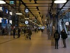 2023 photo - People are walking through the station hall or shopping mall in the back side of Central station, Amsterdam city. Above is the bus station.An urban image of modern interior design of a Mirror Palace. Street photography by Fons Heijnsbroek