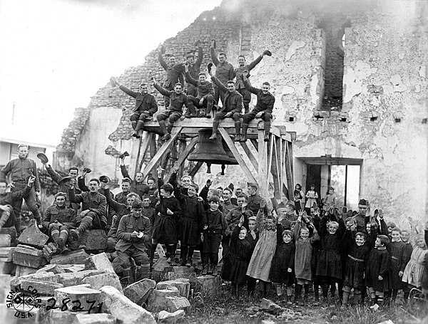 Members of the 305th Field Signal Battalion, 80th Division, with children of the village of Vaubecourt, Meuse, France (21 October 1918)